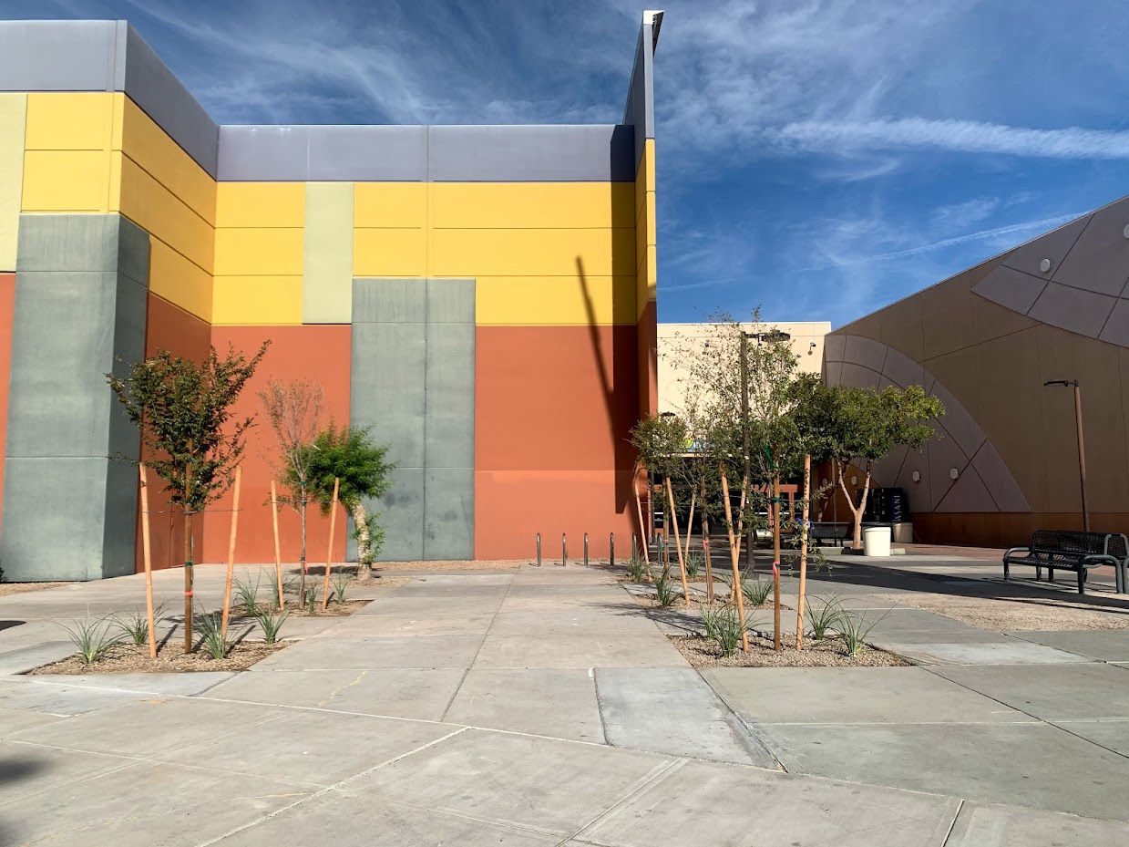 Colorful building with trees and clear sky.