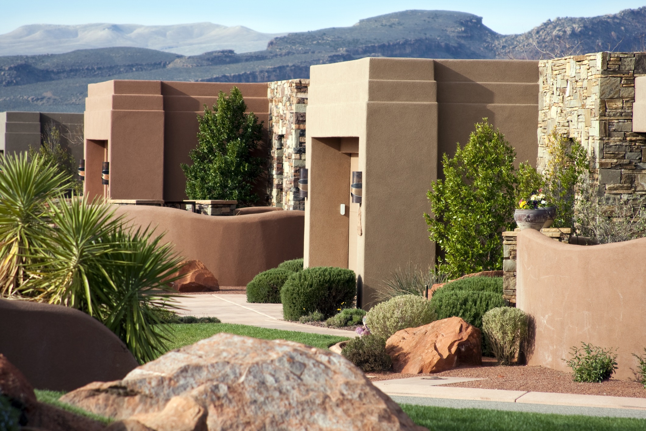 Modern desert house with stone and plant elements.