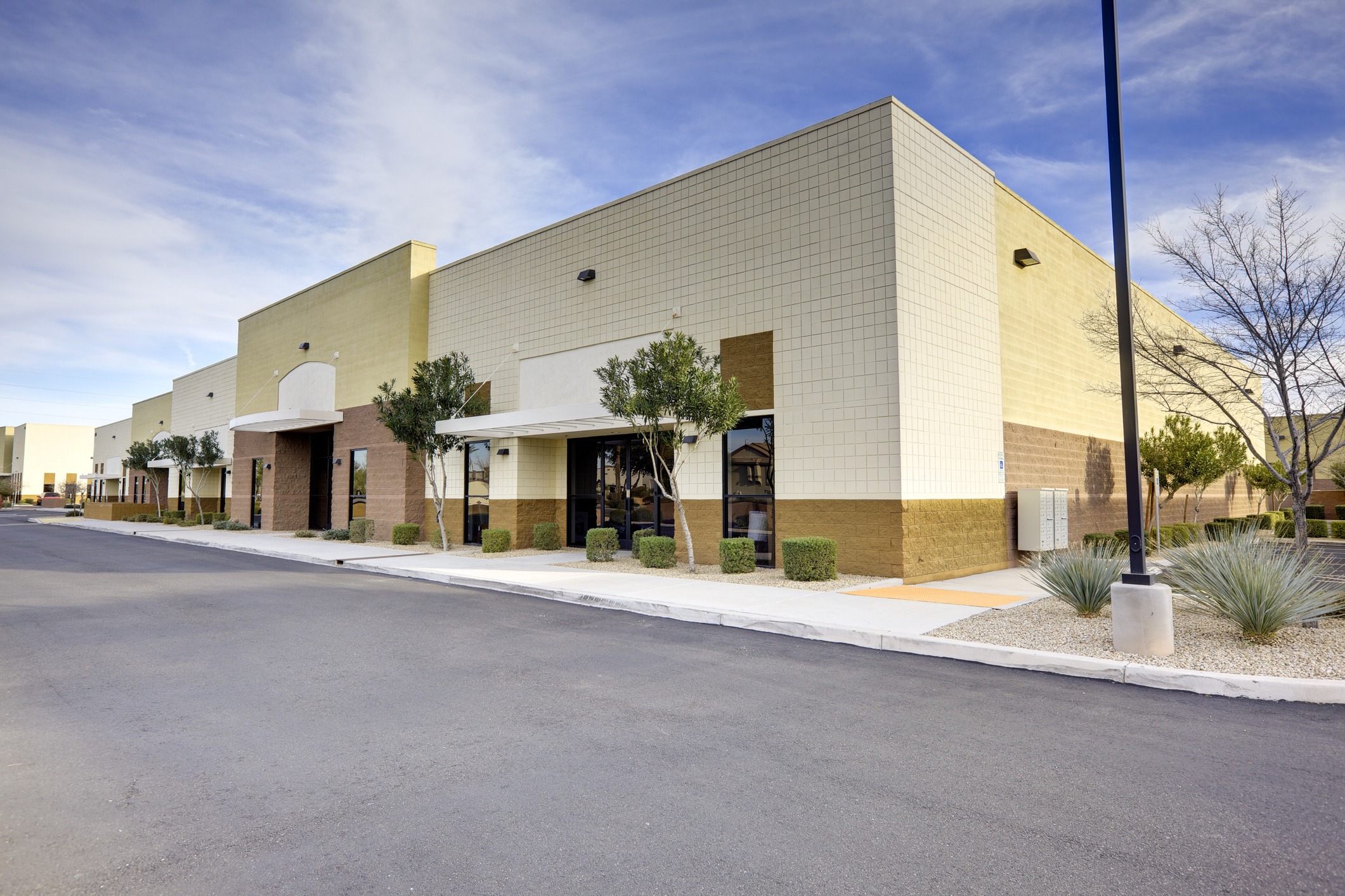 Modern commercial building with parking lot.