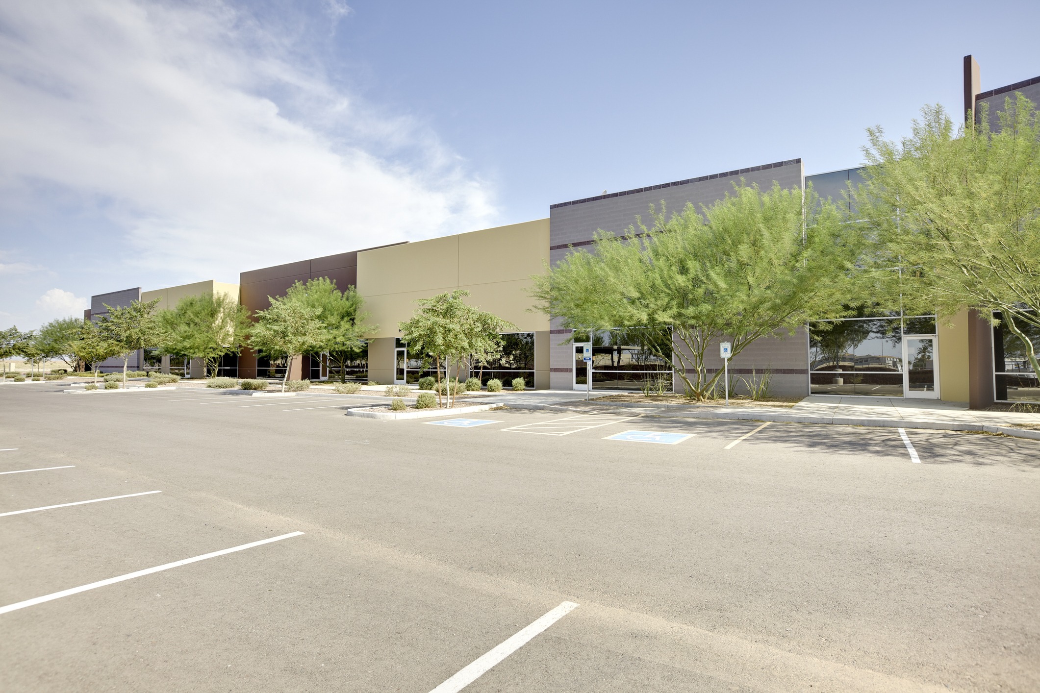Modern office building with parking lot.