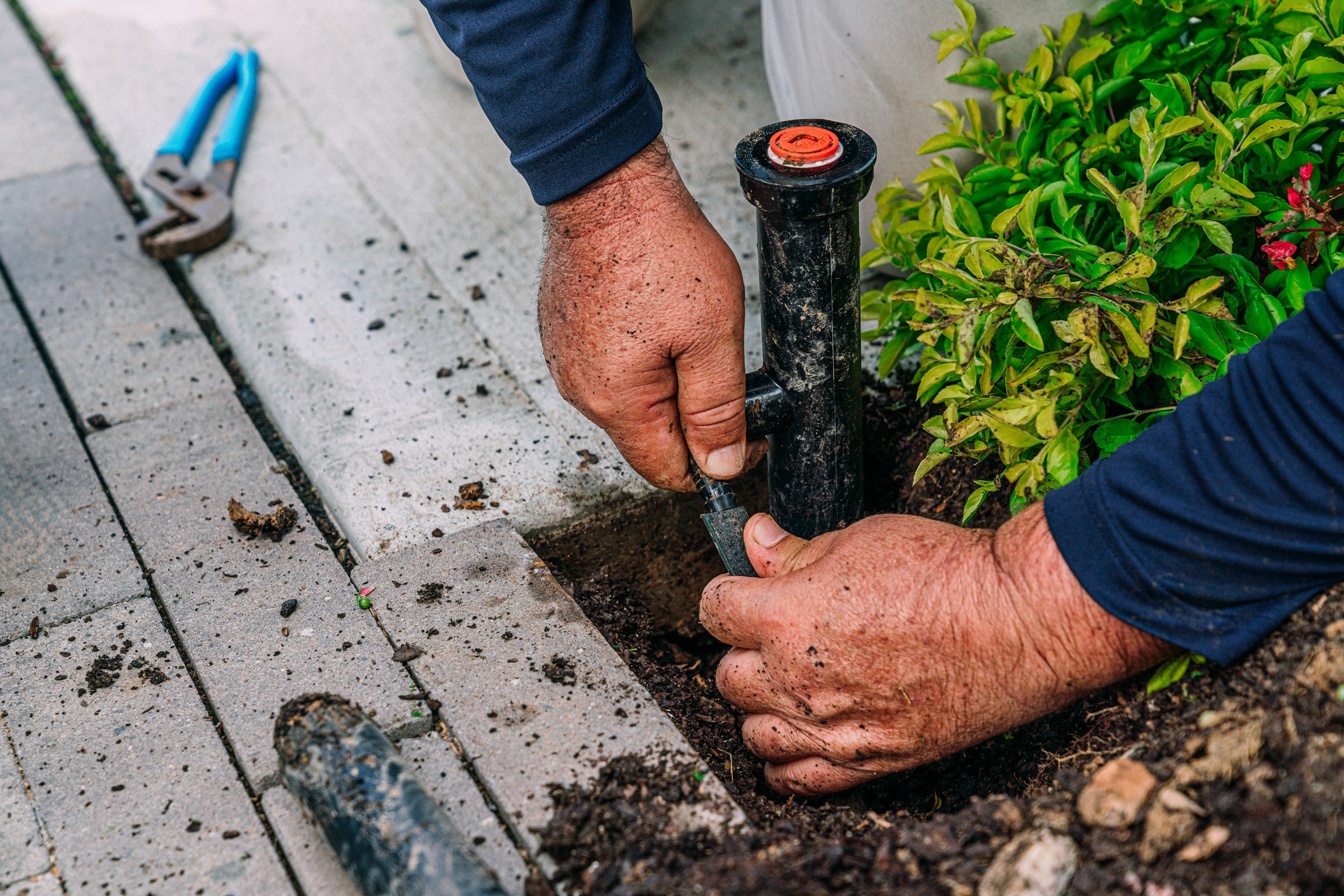 Installing garden sprinkler system by hand