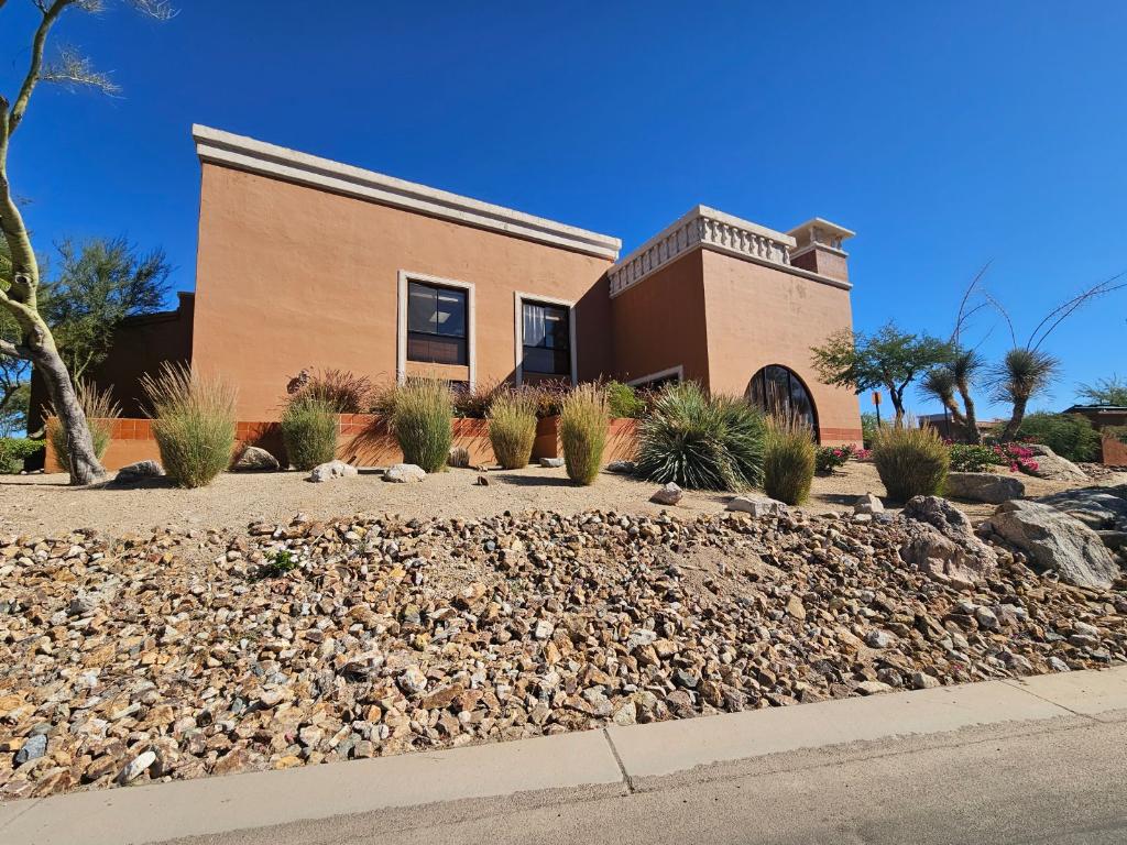 Modern desert home with arid landscape and plants.