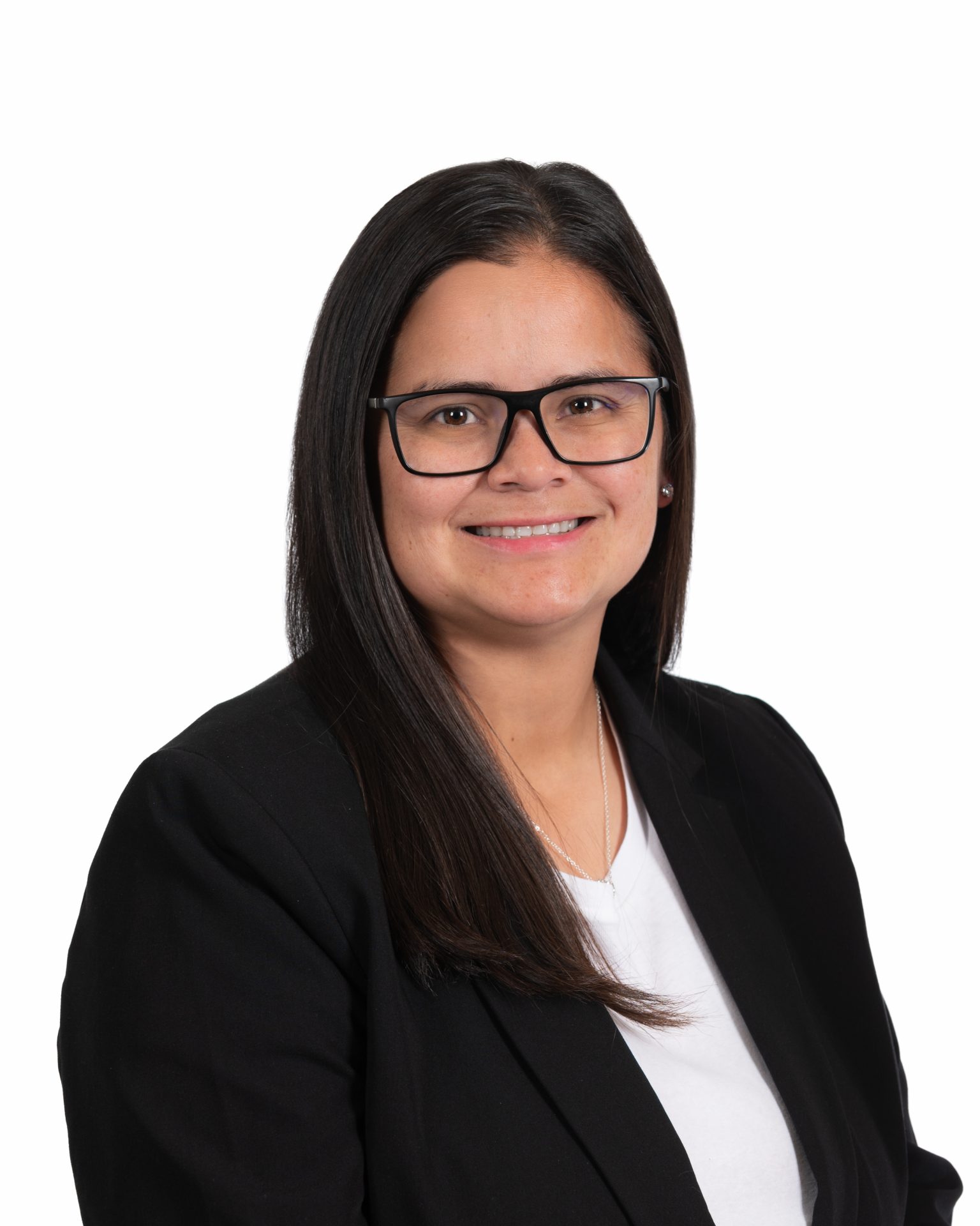 Smiling person with glasses and black blazer