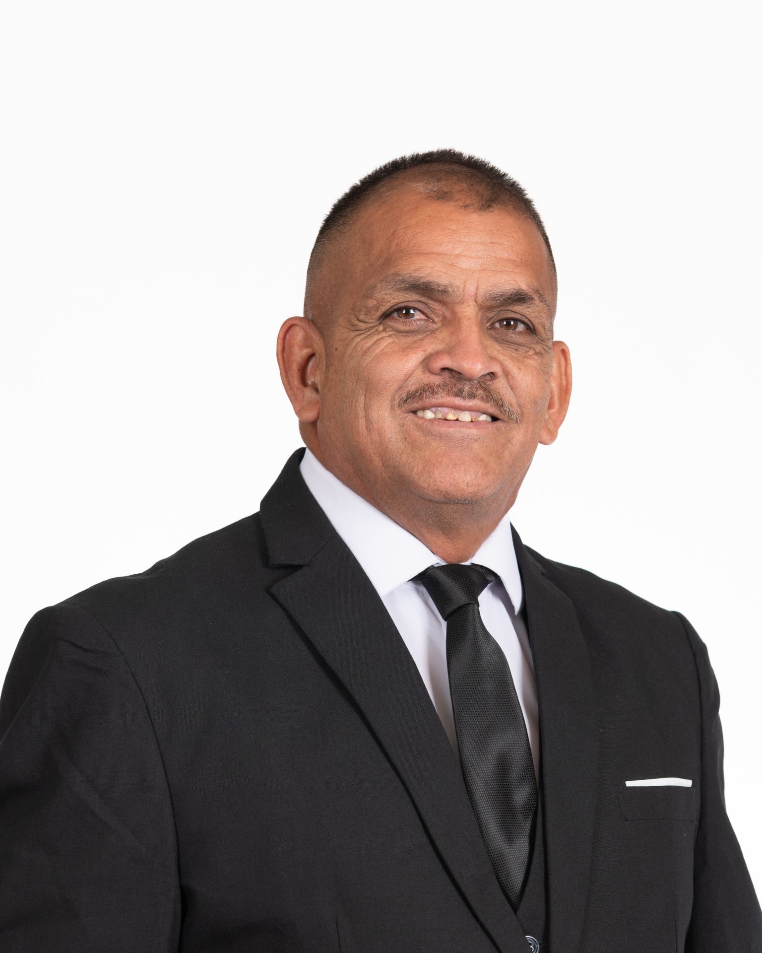 Man in suit with neutral expression.